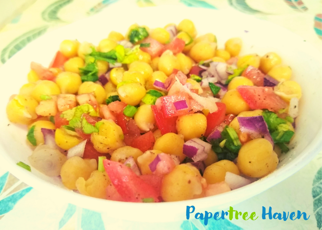 healthy and tasty chana chaat made with cooked chickpeas or chana,  red onions, tomatoes, cilantro, lime/lemon juice, chaat masala, salt, red chili powder (or green chilies), and black salt (optional).